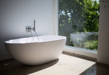 Free Standing Bath Next To Floor To Ceiling Window