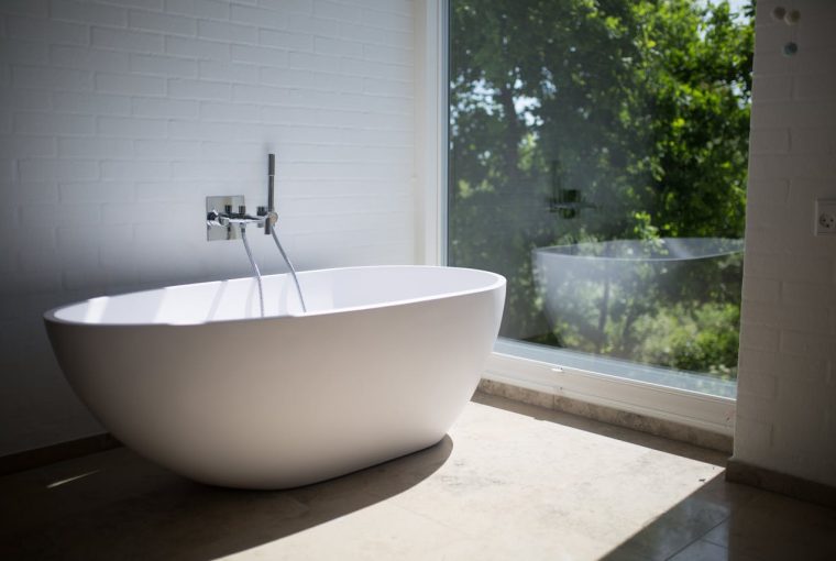 Free Standing Bath Next To Floor To Ceiling Window