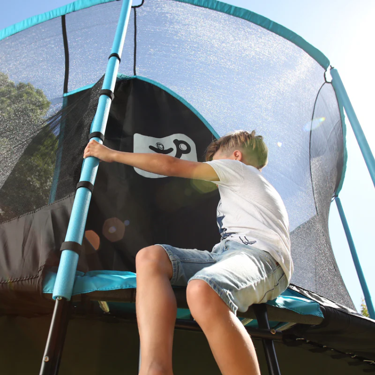 Child sat on black and blue trampoline