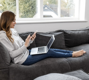 Women sat with laptop on grey bean bag couch