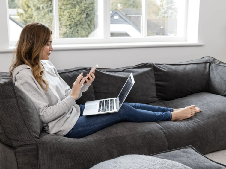 Women sat with laptop on grey bean bag couch