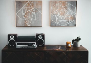 Sideboard with stereo and speakers and artwork on walls