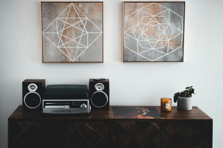 Sideboard with stereo and speakers and artwork on walls