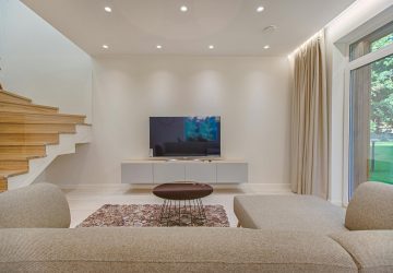 Modern white lounge with contemporary wooden and glass staircase