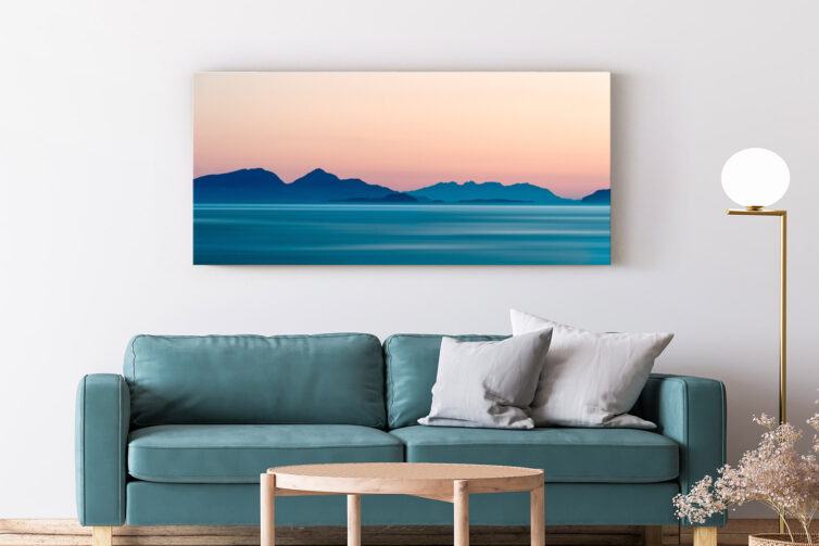 Sofa and coffee table with wall art above the sofa - dawn over the islands canvas print
